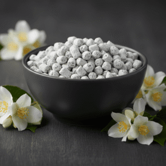 A dark grey, matte-finish ceramic bowl of Jasmine incense, tastefully decorated with fresh jasmine flowers on a dark surface.