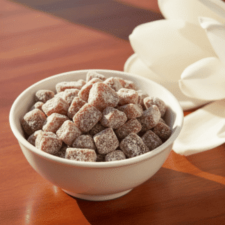 An elegant porcelain bowl of handcrafted Magnolia incense, brightly lit on a polished mahogany surface next to a large, creamy-white magnolia blossom.