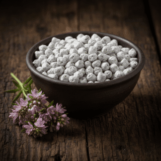 A dark earthenware bowl of handcrafted Nard incense, resting on cracked wood next to a fresh sprig of beautiful spikenard flowers.