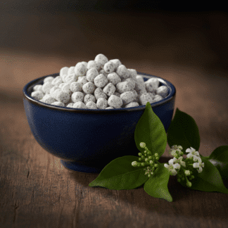 A dark ceramic bowl filled with Night Flower Incense sits on a dark wooden surface, along with a fresh sprig of night flowers.